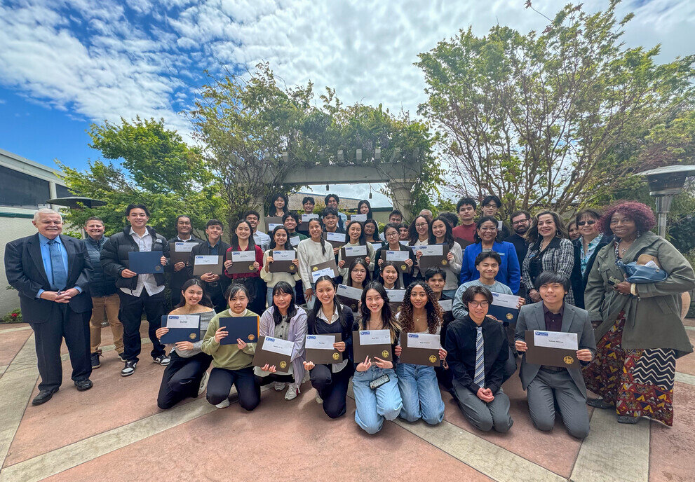 a group of people holding up papers
