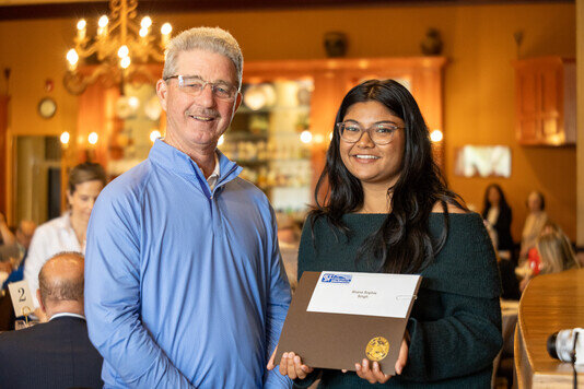 a man and woman holding a certificate