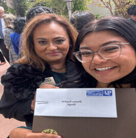 a woman smiling with a envelope