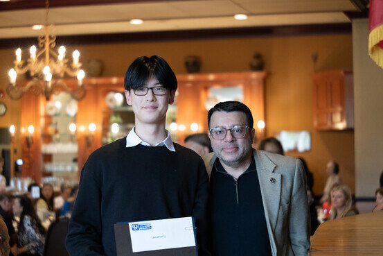 a man holding a folder and smiling