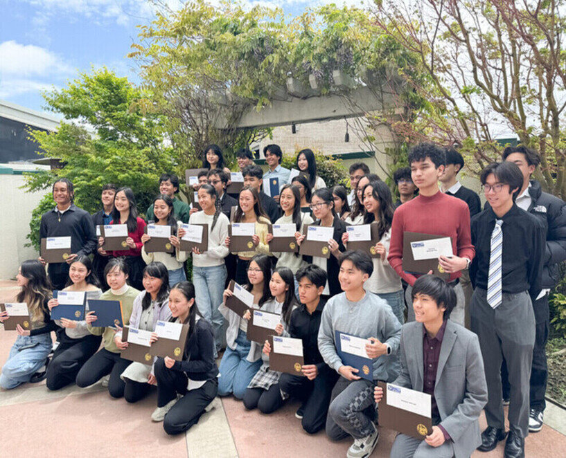 a group of people holding up papers