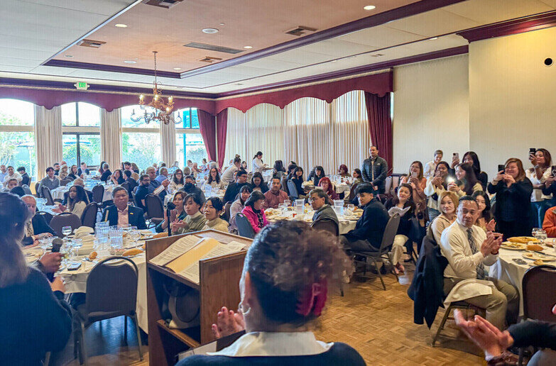 a group of people sitting at tables in a room