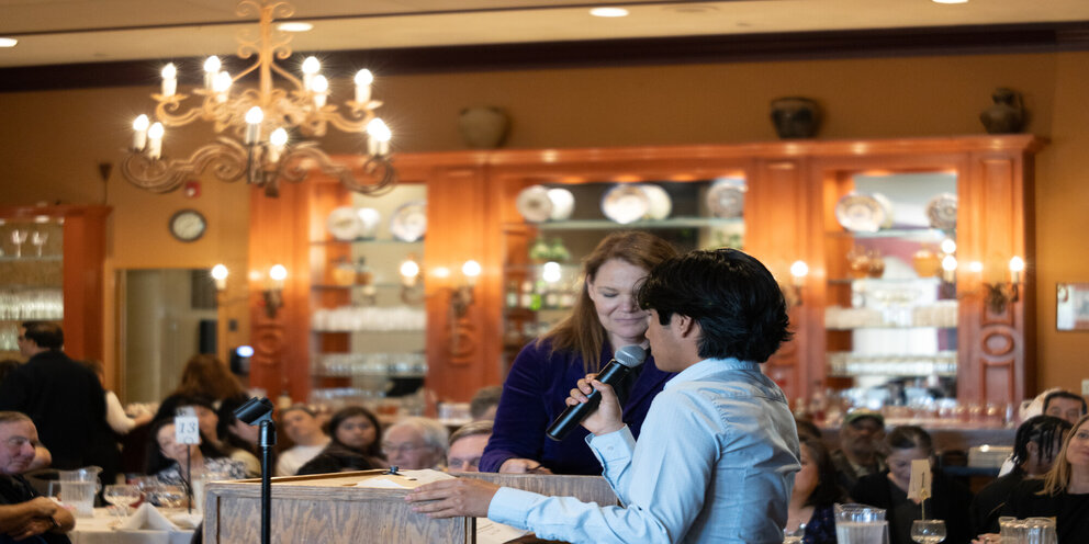 a man and woman talking into a microphone