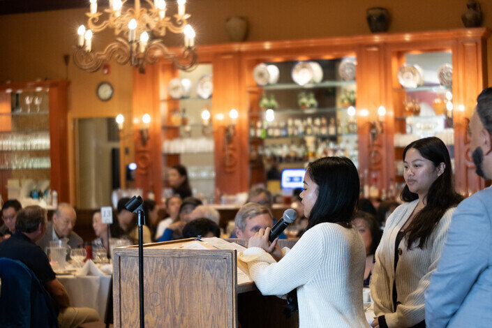 a woman speaking into a microphone