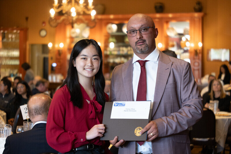 a man and woman holding a certificate