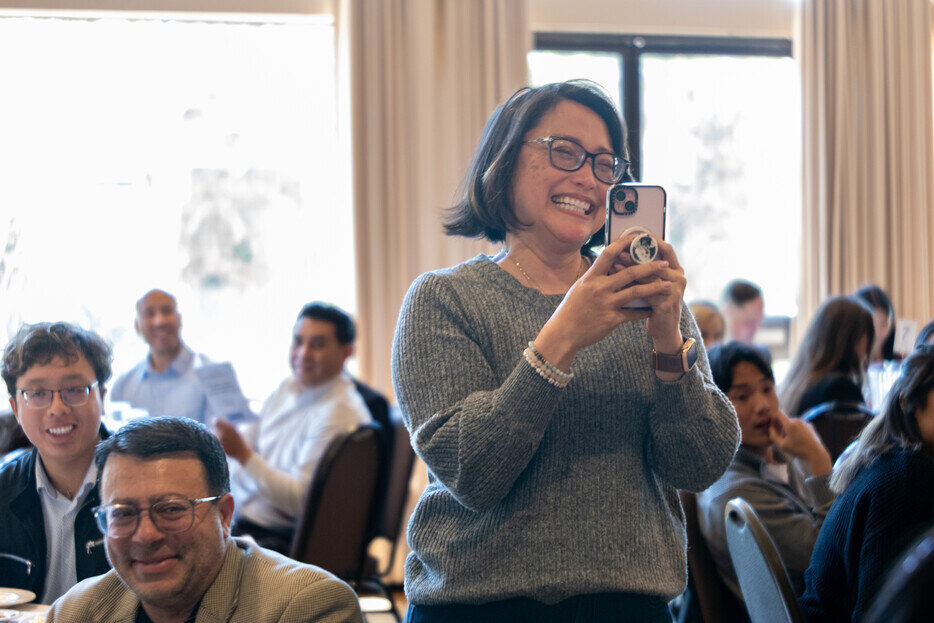 a woman taking a picture of a man