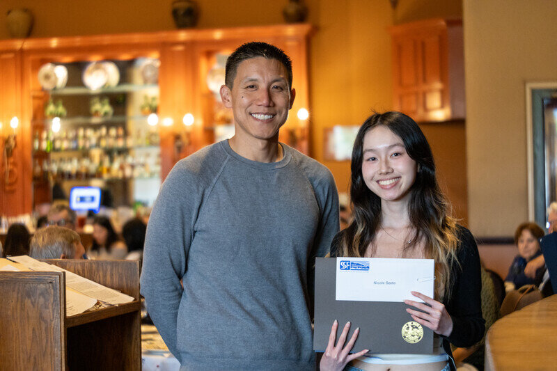 a man and woman holding a certificate