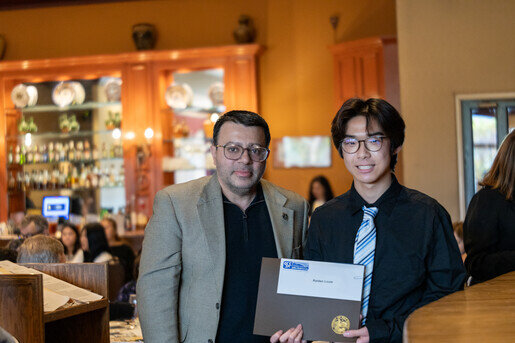 a man holding a certificate and smiling