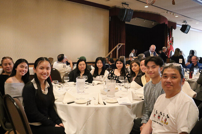 a group of people sitting at a table