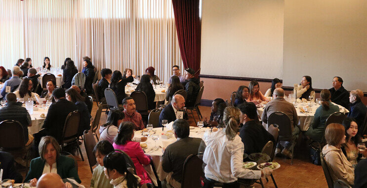 a group of people sitting at tables in a room