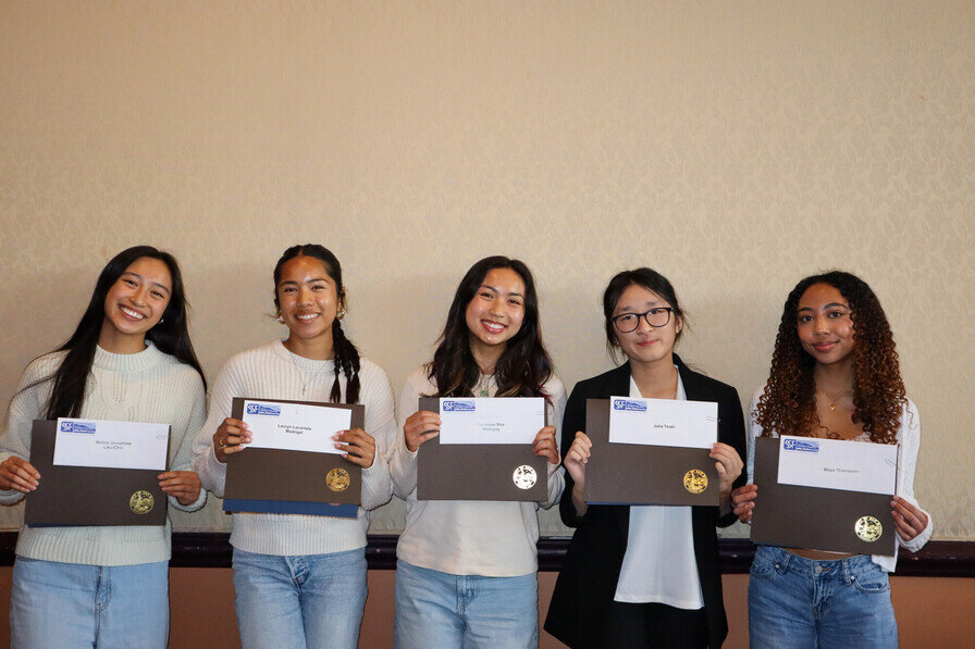 a group of women holding certificates