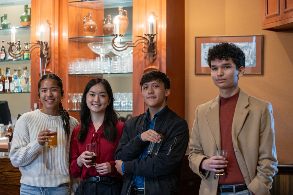 a group of people holding drinks