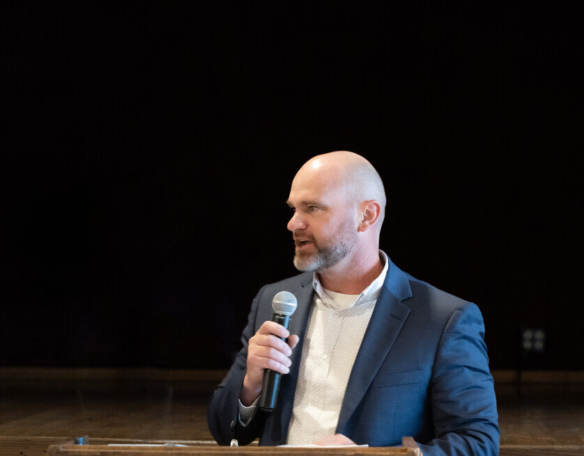 a man in a suit holding a microphone