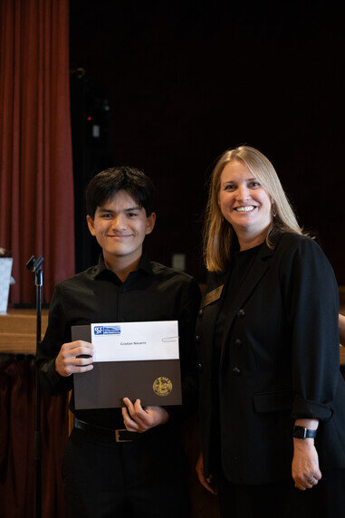 a man and woman holding a certificate