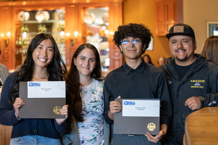 a group of people holding certificates