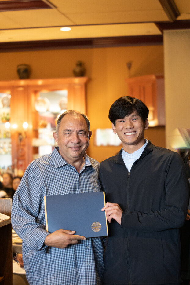 a man holding a blue book