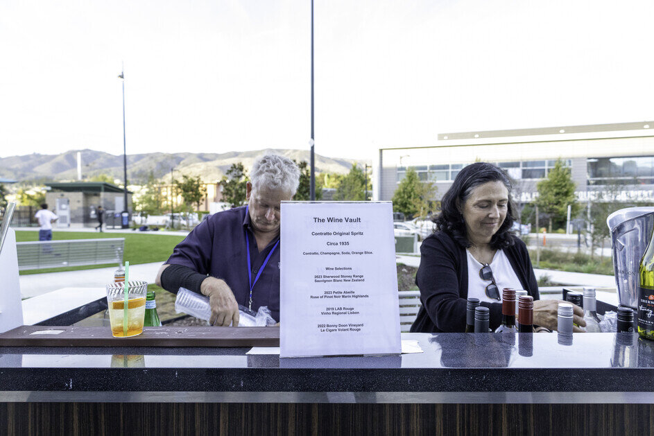 a man and woman standing at a bar