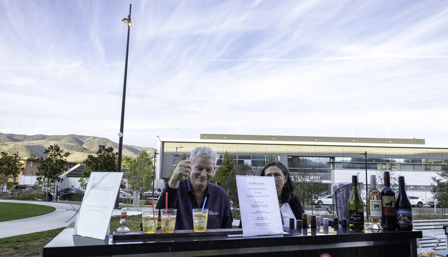 a man giving a thumbs up at a table with drinks