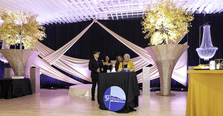 a group of people standing at a table