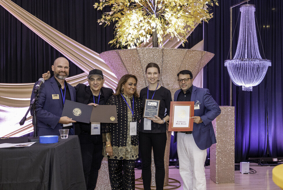 a group of people holding awards