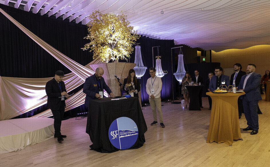 a group of people standing around a table