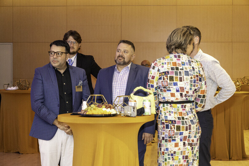 a group of men standing around a table