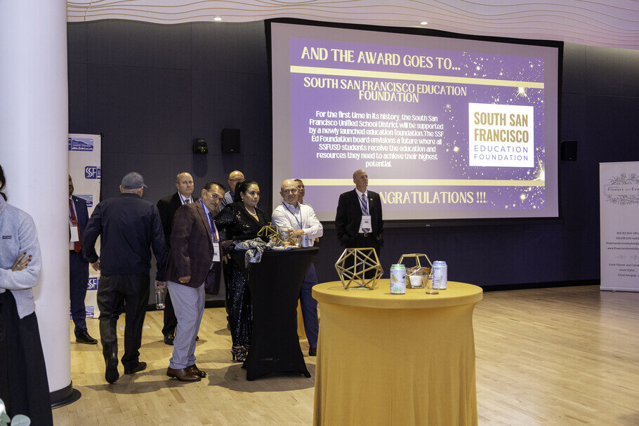 a group of people standing in front of a podium