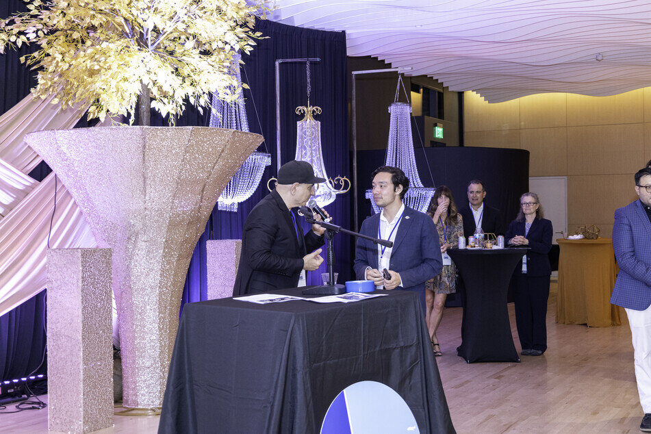 a man holding a microphone to another man
