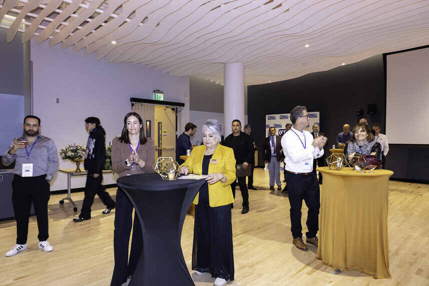 a group of people standing around a table