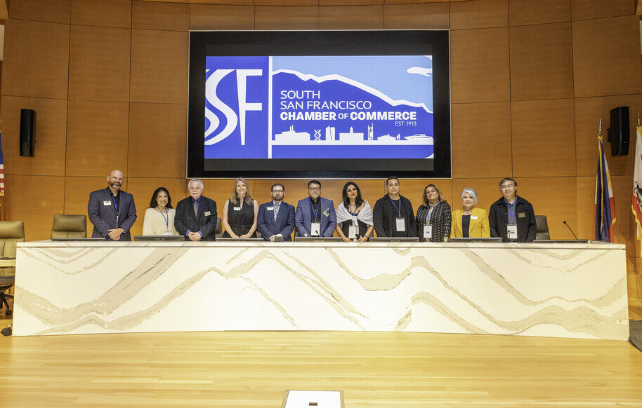 a group of people standing in front of a screen