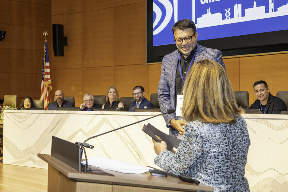 a man standing at a podium with a woman in front of him