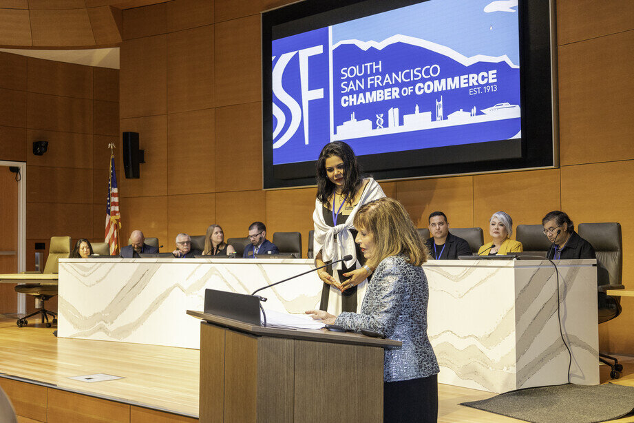 a woman standing at a podium with a microphone