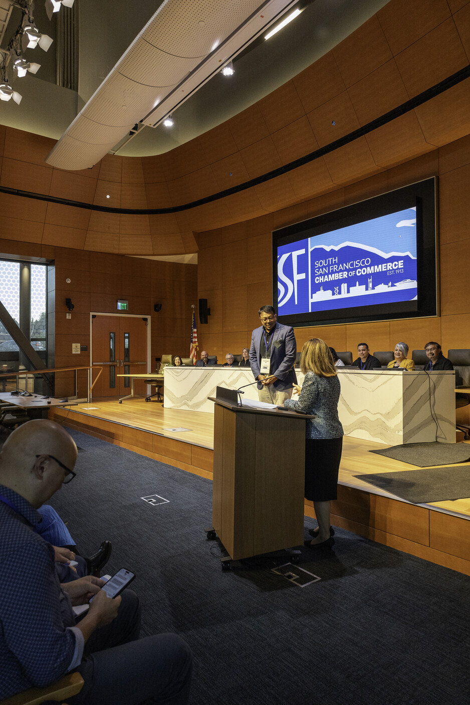 a man standing at a podium with a man standing at a podium