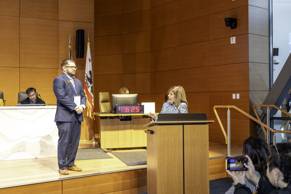 a man standing in front of a podium with a woman in front of him