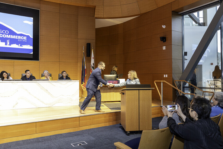 a man shaking hands with a woman on a stage