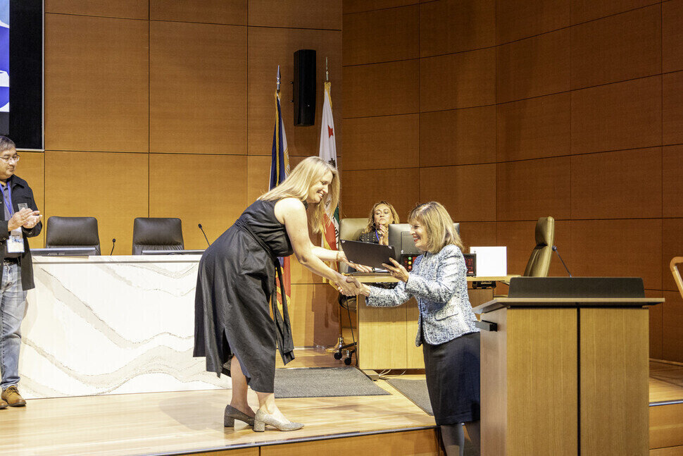 a woman shaking hands with another woman