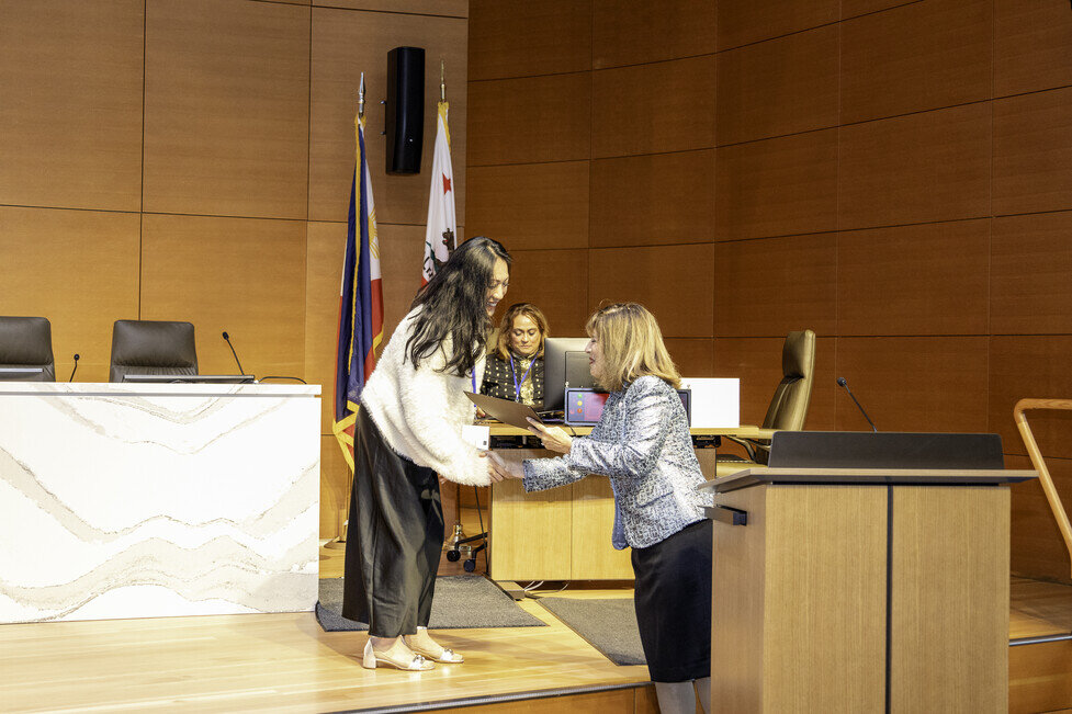 a woman shaking hands with another woman in a room