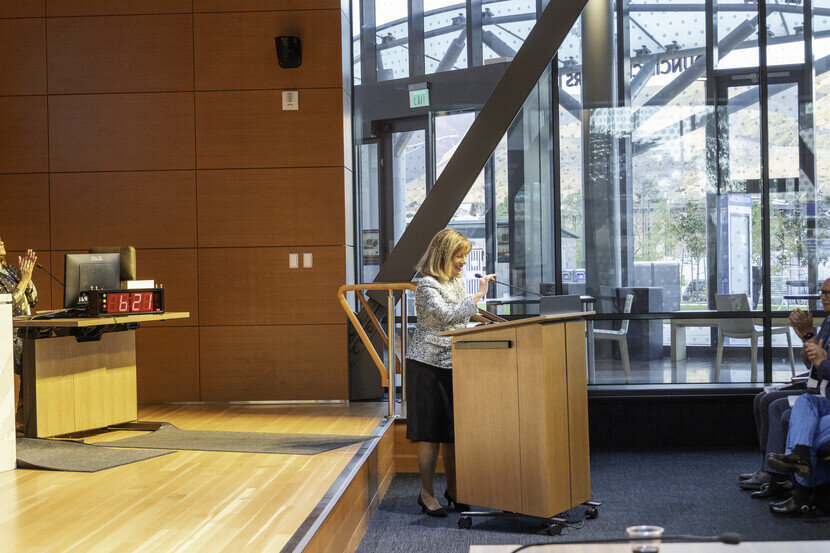 a woman standing at a podium