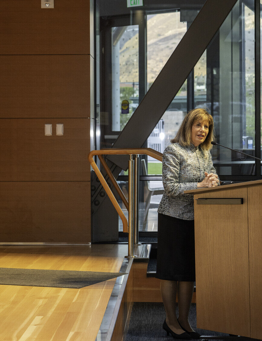 a woman standing at a desk