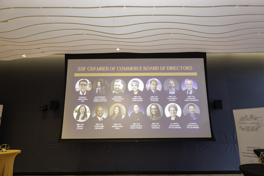 a large screen with a group of people on it
