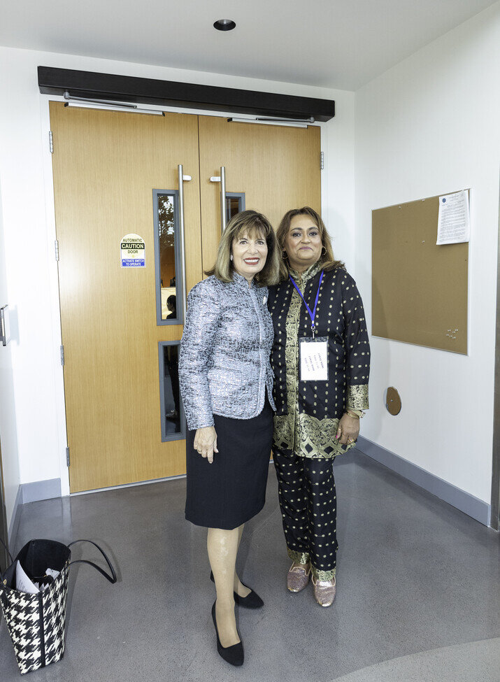 two women standing in front of a door